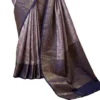 Detailed view of the embossed floral patterns and metallic gold zari weaving on a light blue tissue silk saree