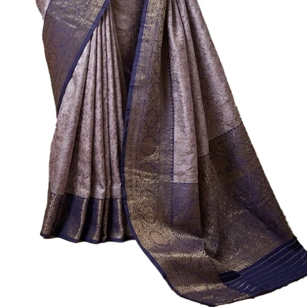 Detailed view of the embossed floral patterns and metallic gold zari weaving on a light blue tissue silk saree