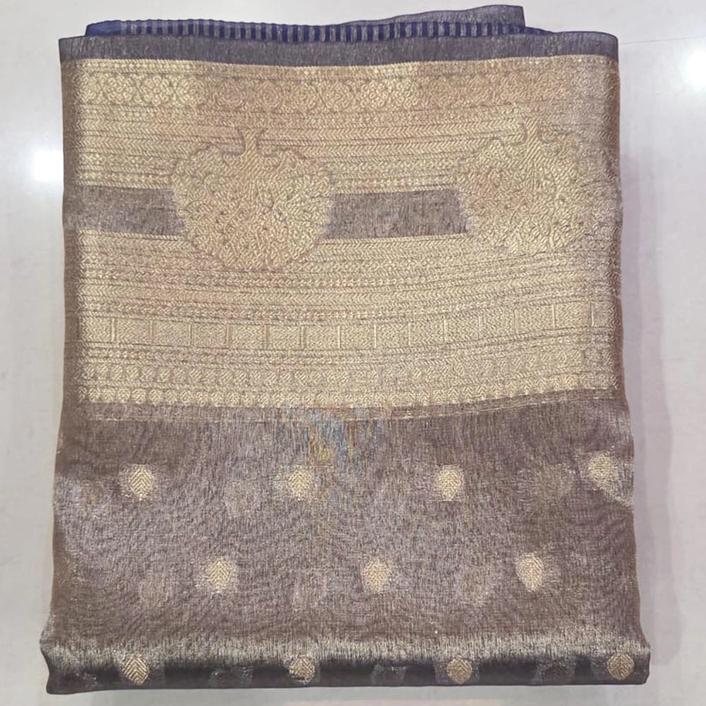 Styling inspiration for a blue Banarasi tissue saree featuring a modern party background.