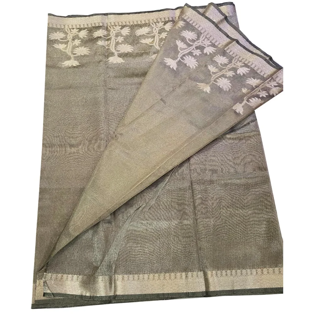 Model in a sitting pose wearing a Pistachio Green Banarasi silk tissue saree with a shimmering metallic finish and antique gold floral zari border